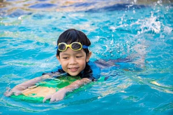 boy swimming in heated swimming pool